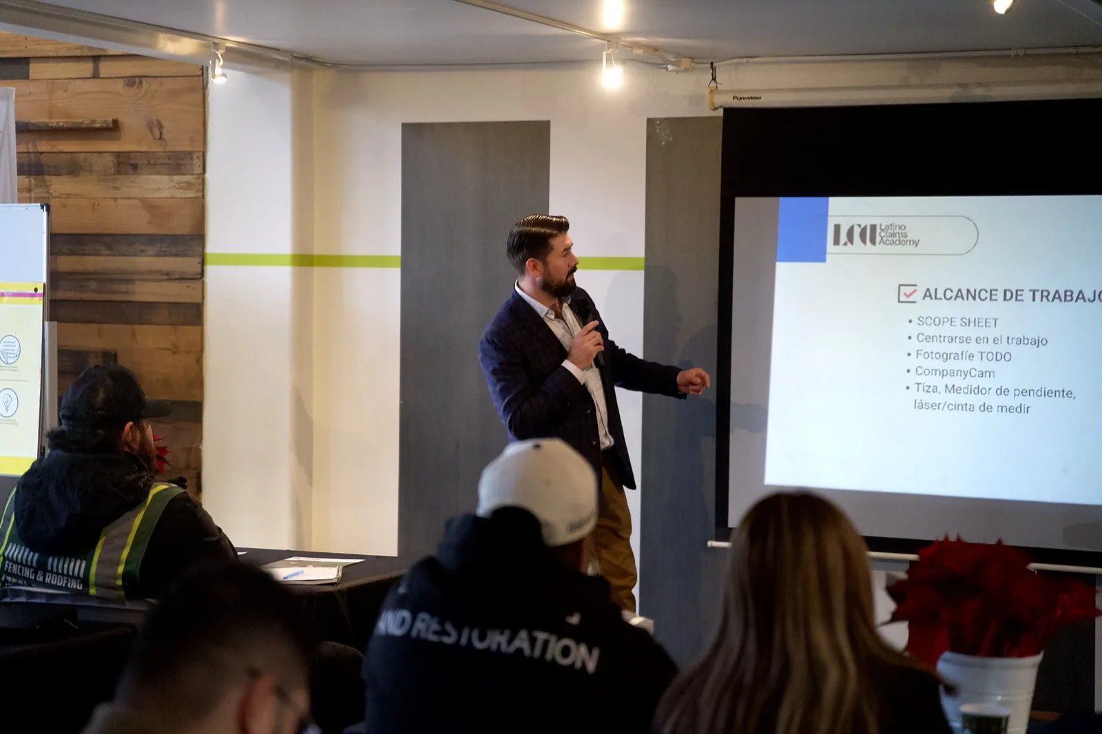 A speaker presenting to a full room at a company training in the Main Hall at 1712 Studios