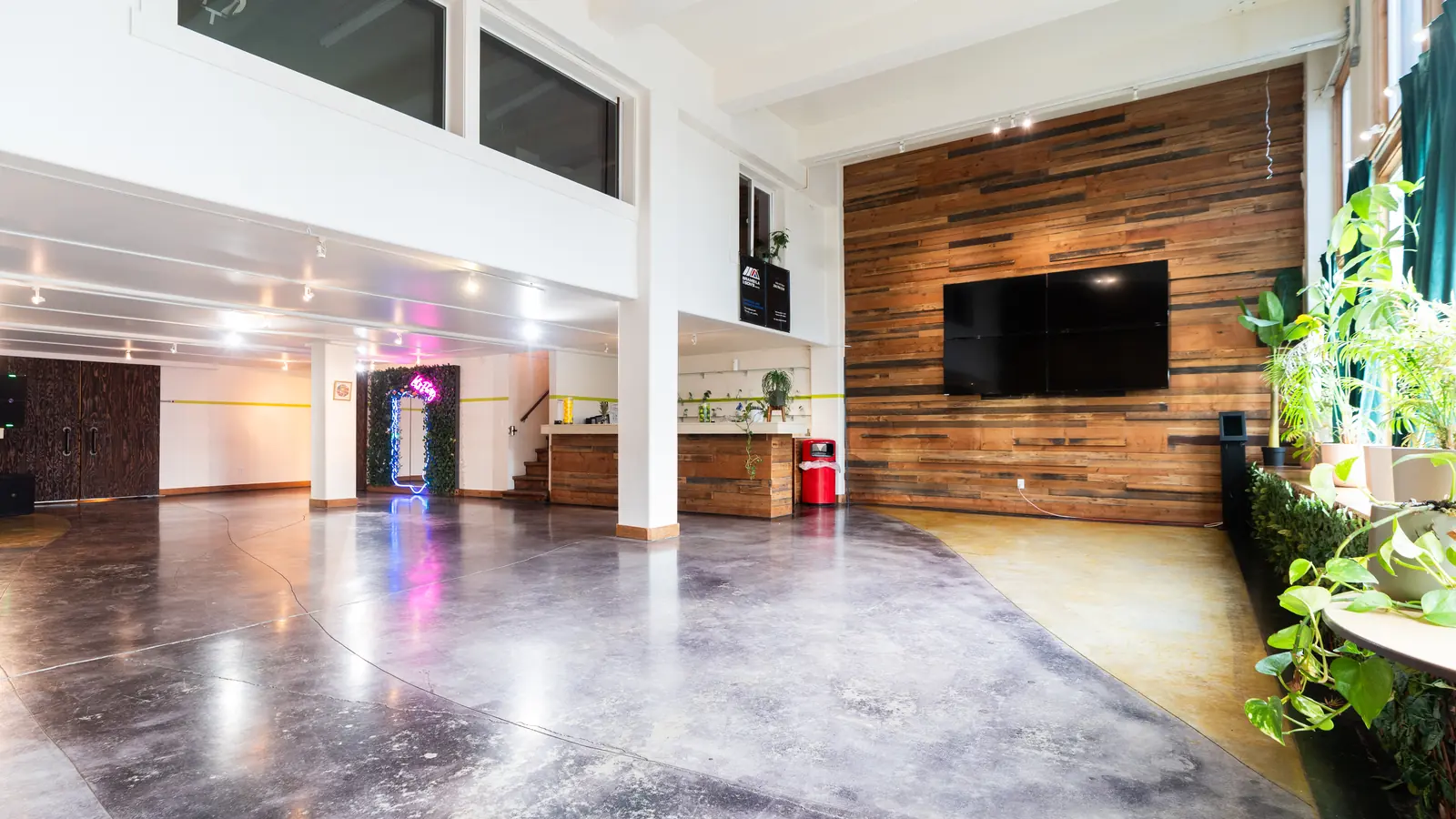 The Main Hall at 1712 Studios in Seattle: polished concrete floor, reclaimed wood wall and the 110 inch screen